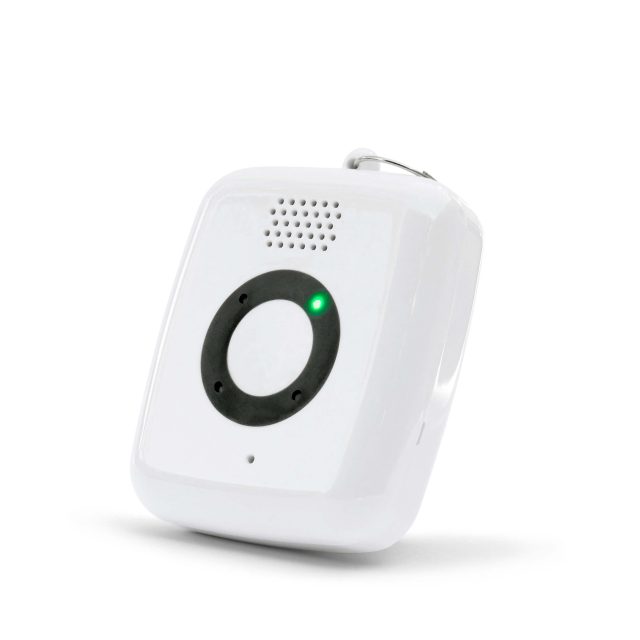 A white electronic device with a circular black button in the center, a green indicator light, speaker holes, and a small loop at the top for attachment.